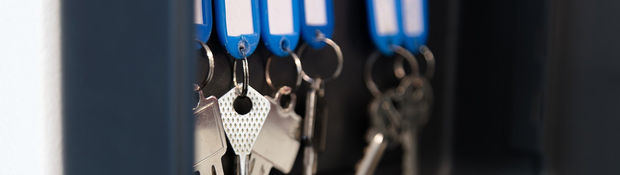 Hanging keys in metal box with on empty spot Hanging keys in metal box with on empty spot