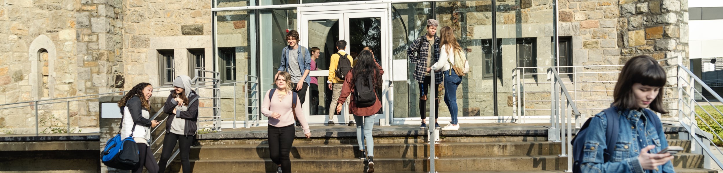 Higher ed building with students coming and going_banner-1