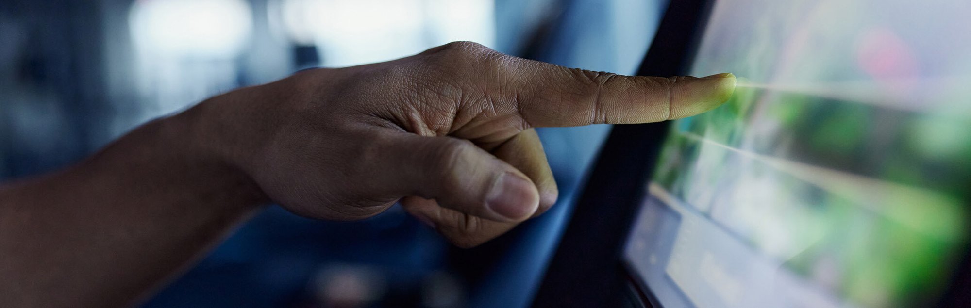 Close-up of hand selecting option on touchscreen