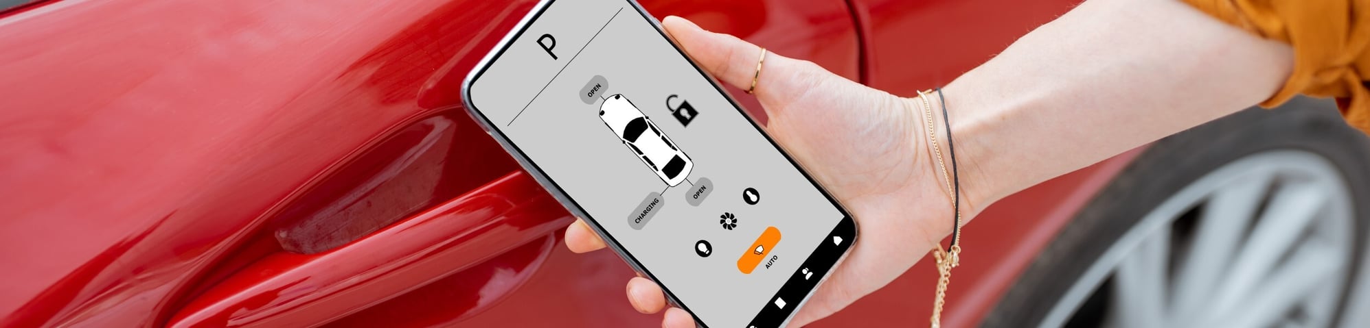 Women opening red car with mobile app
