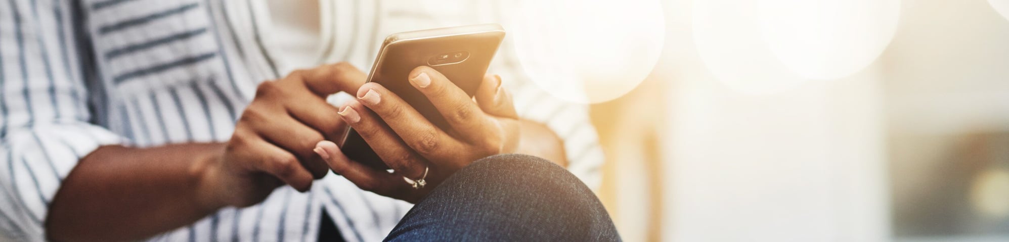 Woman sitting looking at phone